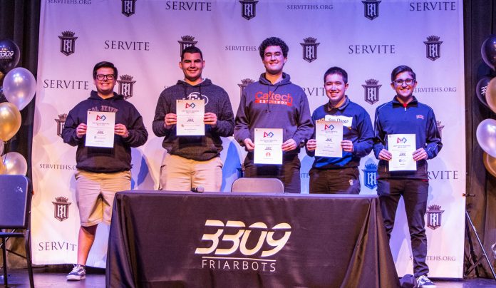 Servite students and Team 3309 team members, Brandon Capparelli, Jonah Bomwell, Chase Blagden, Max Kowalski, and Andrew Hogue hold their signed letters of intent at the second annual FIRST Robotics Signing Day